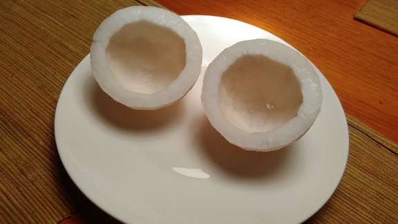 Two halves of a skinned and clean coconut